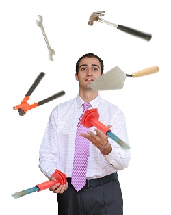 Businessman juggling hand tools